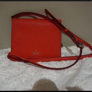 Red crossbody Kate spade bag.